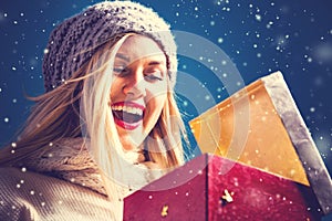 Happy young woman with Christmas present box