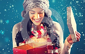 Happy young woman with Christmas present box