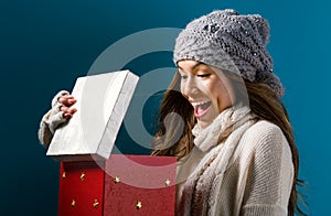 Happy young woman with Christmas present box