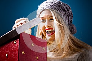 Happy young woman with Christmas present box