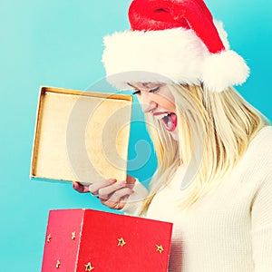 Happy young woman with Christmas present box