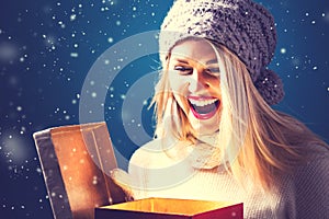 Happy young woman with Christmas present box