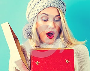 Happy young woman with Christmas present box