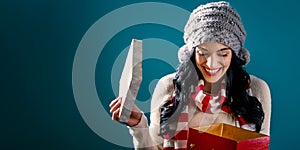 Happy young woman with Christmas present box