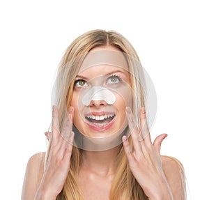 Happy young woman with clear-up strips on nose