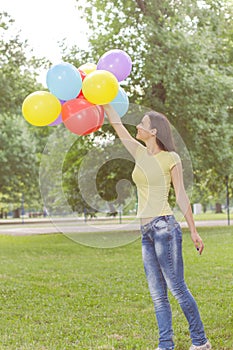 Happy Young Woman With Colorful Balloons