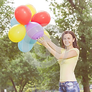 Happy Young Woman With Colorful Balloons