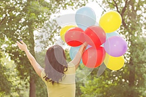 Happy Young Woman With Colorful Balloons