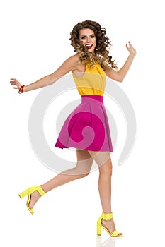 Happy Young Woman In Colorful High Heels And Pink Mini Skirt Is Running