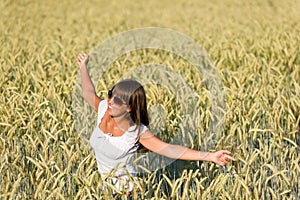 Happy young woman in corn field enjoy sunset