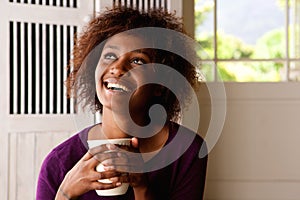 Happy young woman with cup of coffee