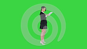 Happy Young Woman Dancing Listening To Music On Tablet PC on a Green Screen, Chroma Key.