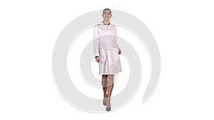 Happy young woman doctor dances on white background.