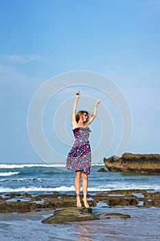 happy young woman in dress jumping