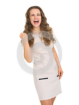 Happy young woman in dress showing yes gesture