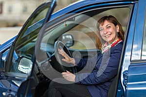 Happy young woman driving her new car. Hobby.