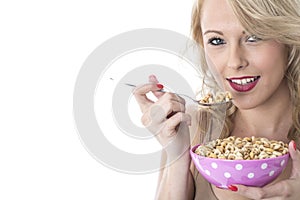 Happy Young Woman Eating Breakfast Cereals