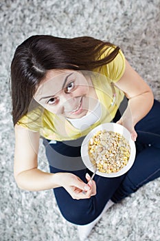 Happy Young Woman Eating Cereal Breakfast