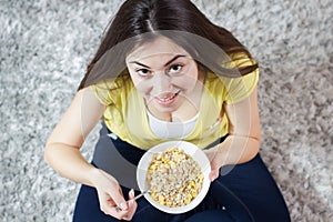 Happy Young Woman Eating Cereal Breakfast