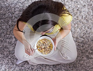 Happy Young Woman Eating Cereal Breakfast