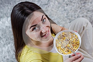 Happy Young Woman Eating Cereal Breakfast