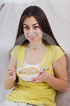 Happy Young Woman Eating Cereal Breakfast