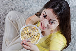 Happy Young Woman Eating Cereal Breakfast