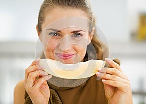 Happy young woman eating melon