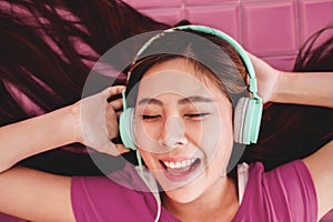 Happy Young Woman Enjoying with Music From Headphone, Smiling an photo