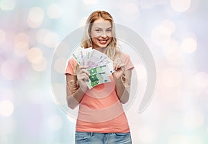 Happy young woman with euro cash money