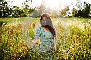 Happy young woman in the evening field