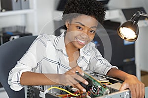 Happy young woman fixing pc computer