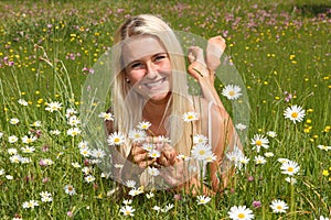 Happy young woman on a flower meadow