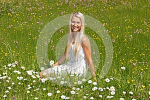 Happy young woman on a flower meadow