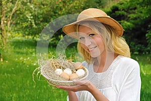 Happy young woman and fresh eggs