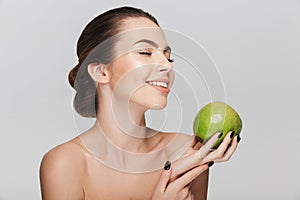 happy young woman with fresh green apple