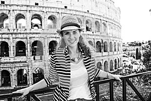 Happy young woman in front of Colosseum in Rome, Italy