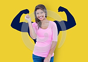 happy young woman in front of fists dark blue draw on yellow wall