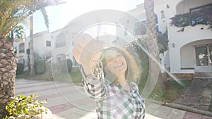 Happy young woman In Front of New Home with Keys