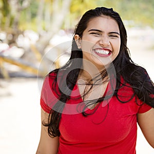 Happy young woman girl with a big smile by the beach enjoying the sunshine. Square composition
