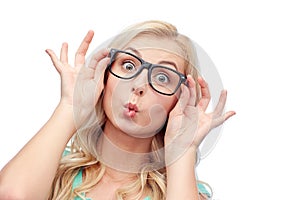 Happy young woman in glasses making fish face