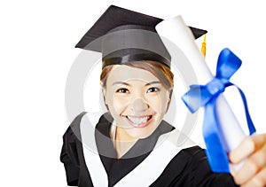 happy young woman graduating holding diploma