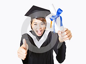 Happy young woman graduating showing thumb up