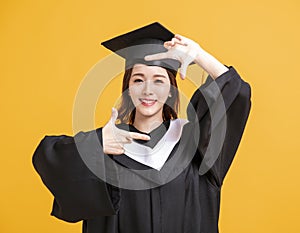 Happy young woman in graduation gowns with looking gesture