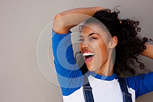 Happy young woman with hand in hair