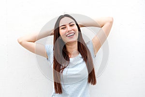 Happy young woman with hands by head in relaxation
