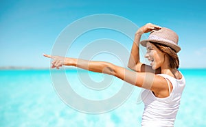 Happy young woman in hat on summer beach