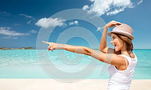 Happy young woman in hat on summer beach