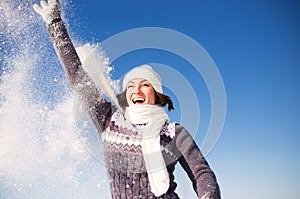 Happy young woman have fun and enjoy fresh snow