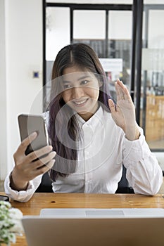 Young woman having video call on her smart phone.